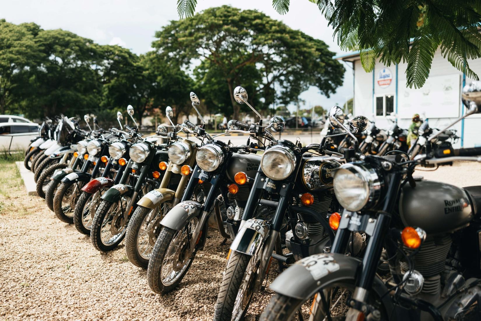 Motorcycle riders on gravel road with Mount Kilimanjaro in background